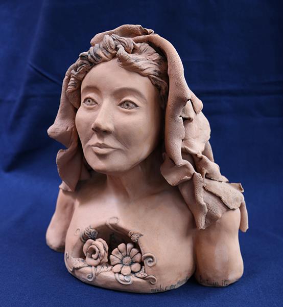 sculpture of a bust with flowers blooming from within